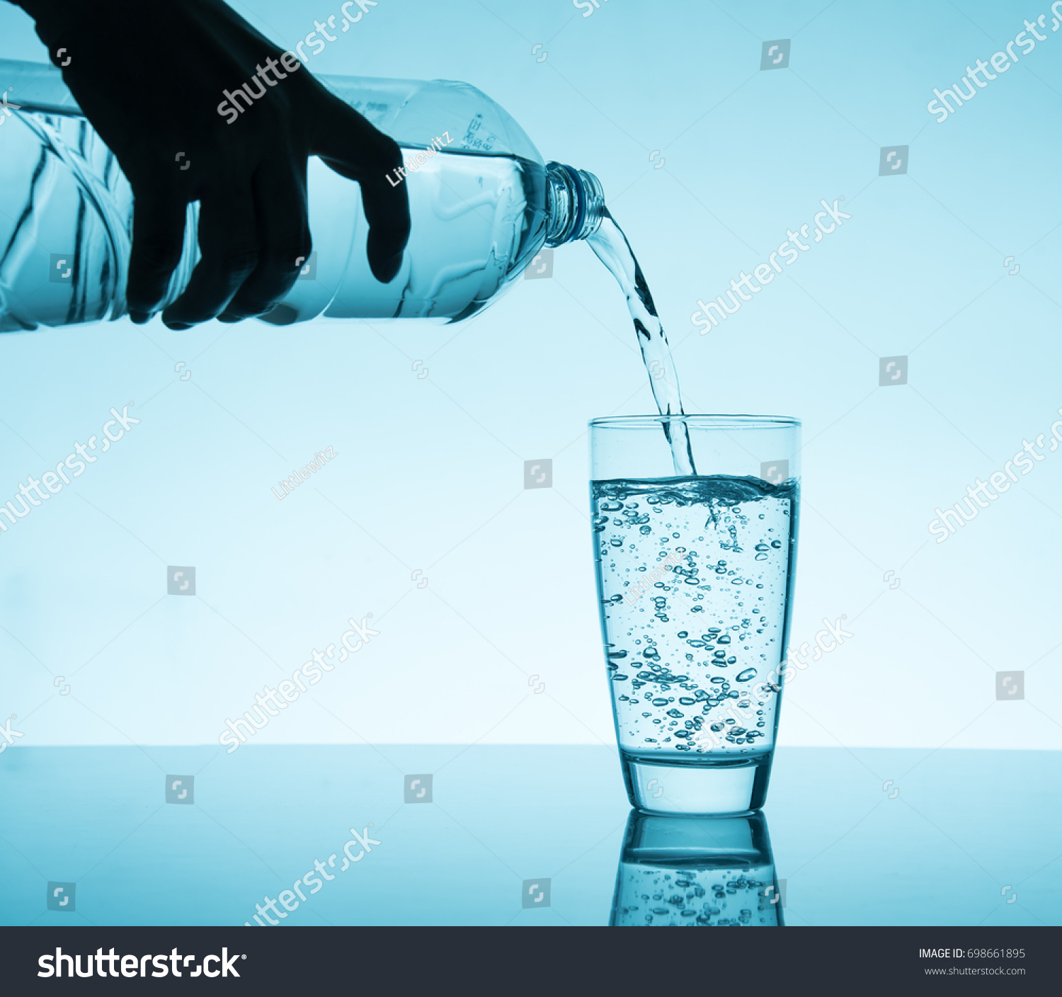 Pouring Water Into Glass Blue Background Stock Photo 698661895 ...