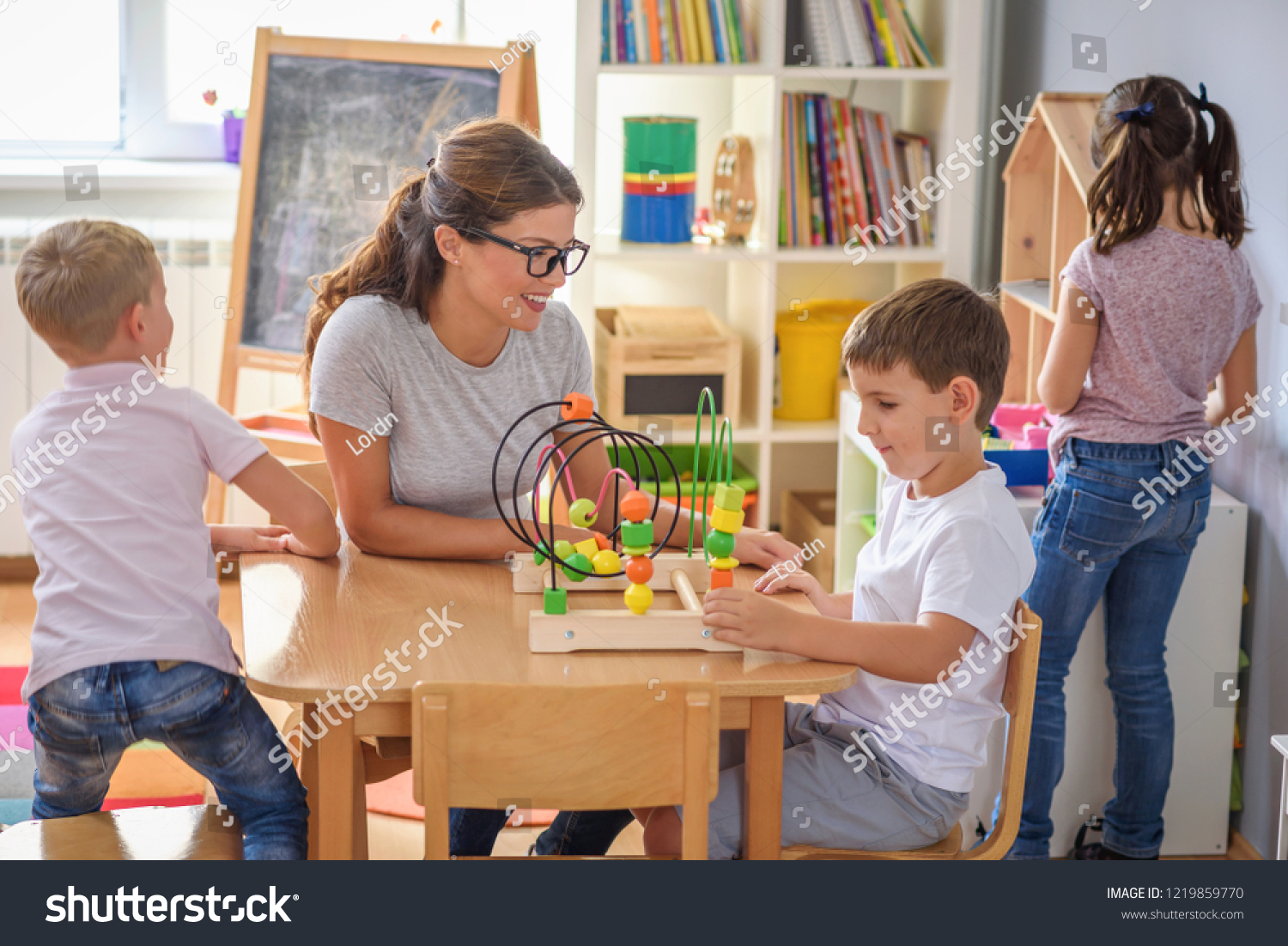 Preschool Teacher Children Playing Colorful Wooden Stock Photo