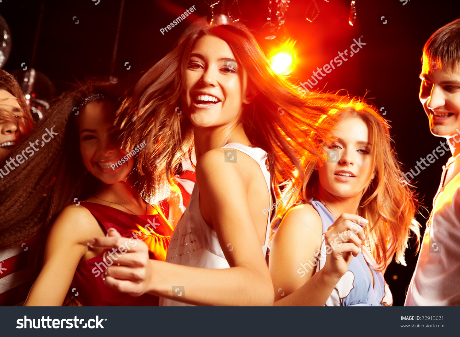 Pretty Clubber Dancing Surrounded By Her Friends And Looking At Camera ...