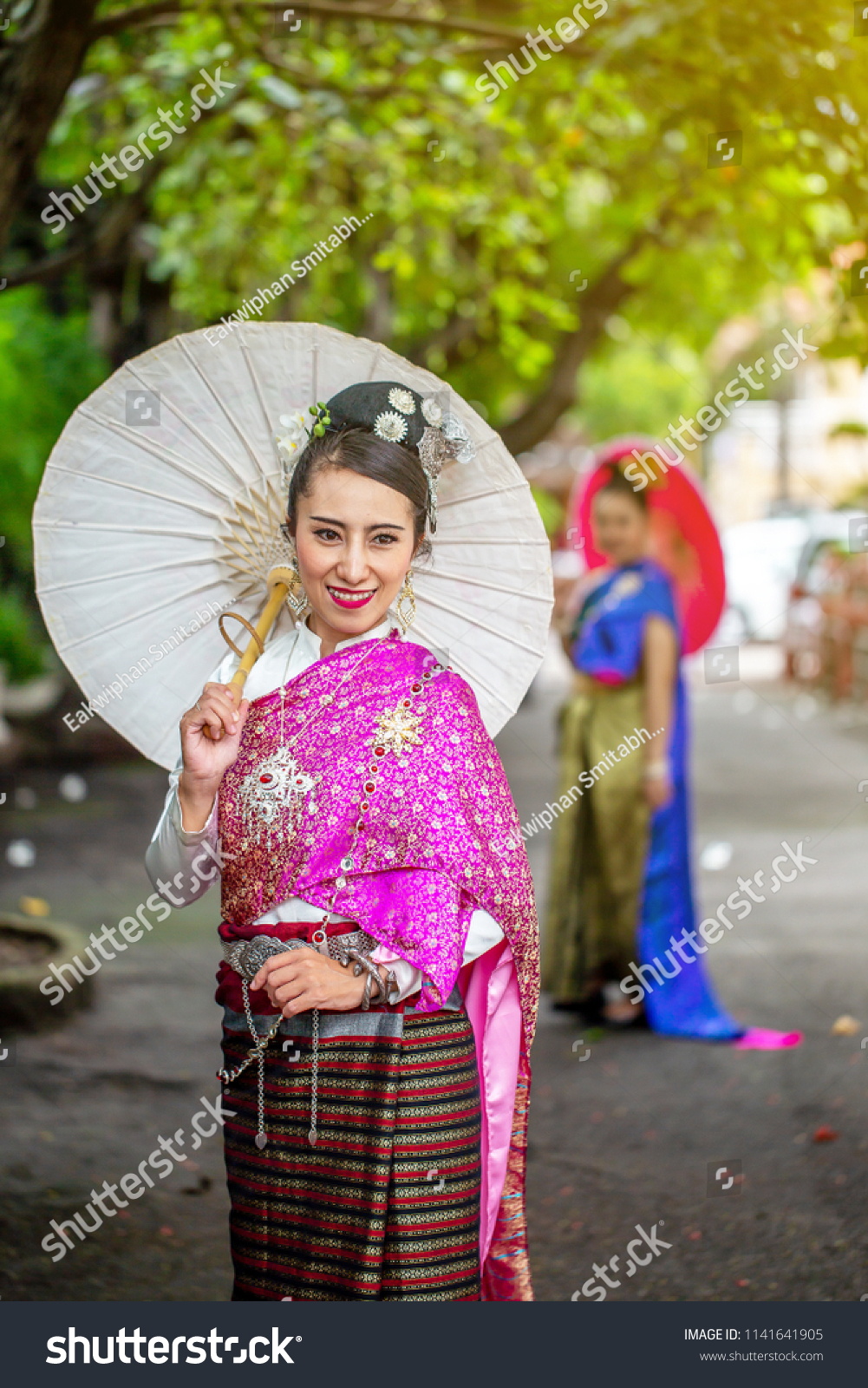https://image.shutterstock.com/z/stock-photo-pretty-thai-women-in-the-northern-thailand-traditional-dress-with-colourful-robe-and-nice-hair-pin-1141641905.jpg