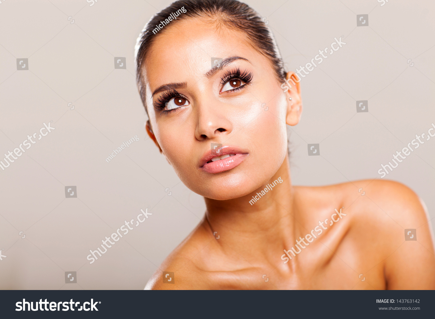 Pretty Woman Beauty Shot On Plain Background Looking Up Stock Photo ...