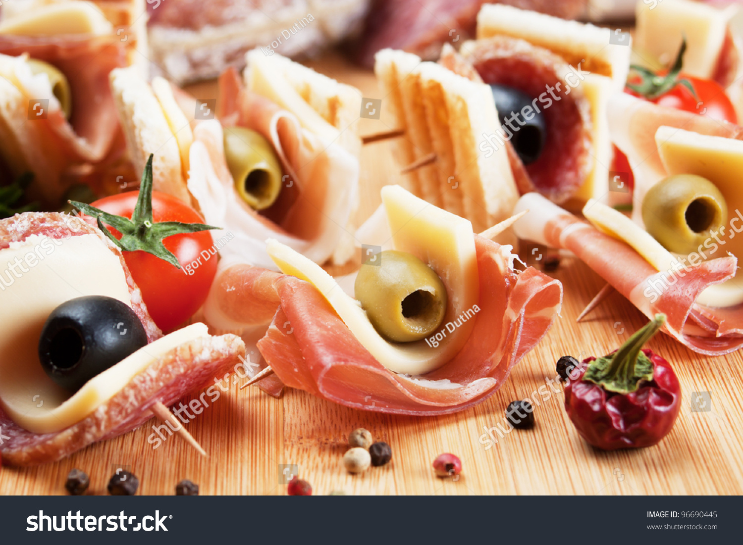 Prosciutto, Salami, Cheese And Olive Canape Appetizer On Wooden Board ...