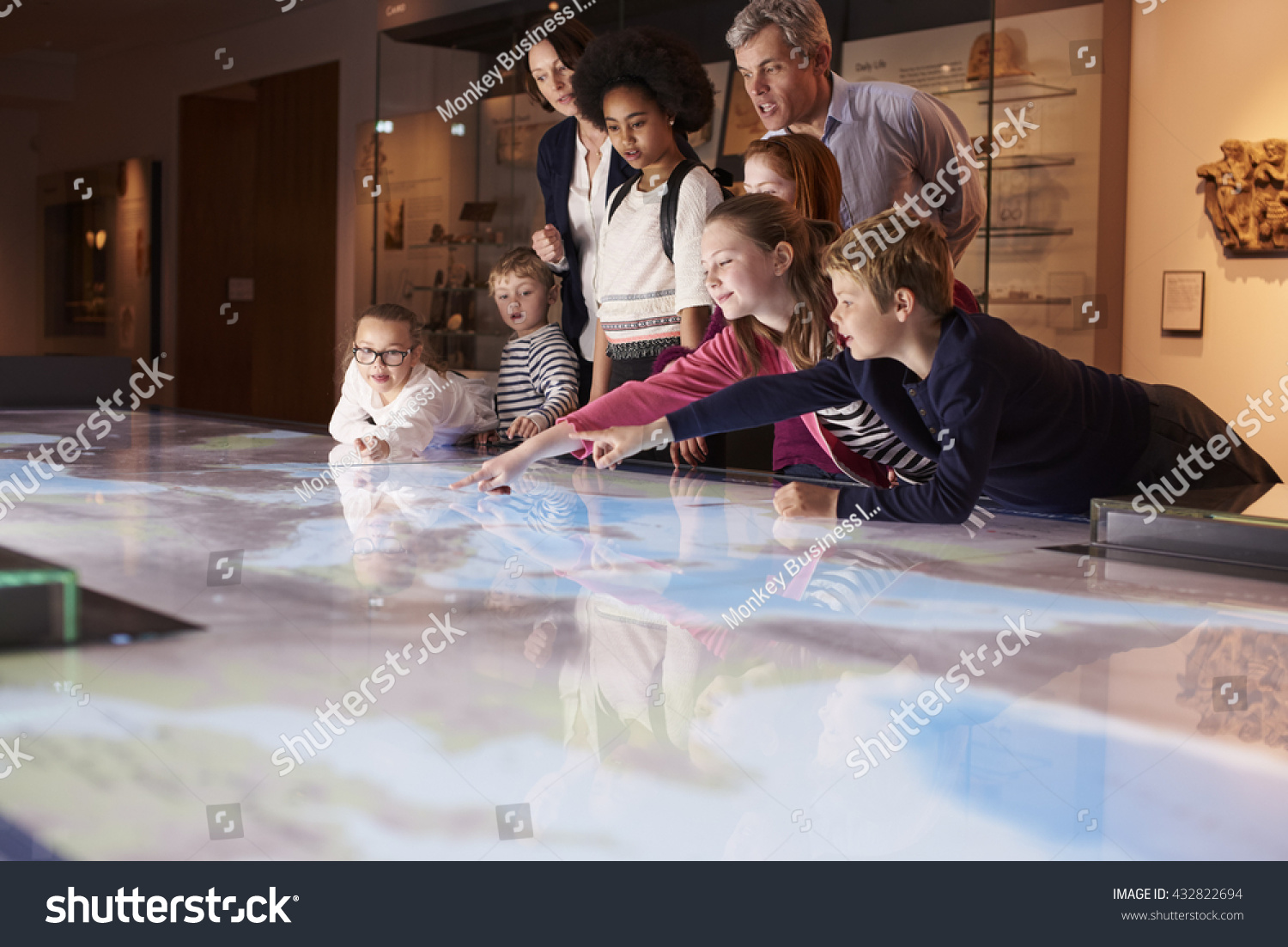 Stock Photo Pupils On School Field Trip To Museum Looking At Map 432822694 