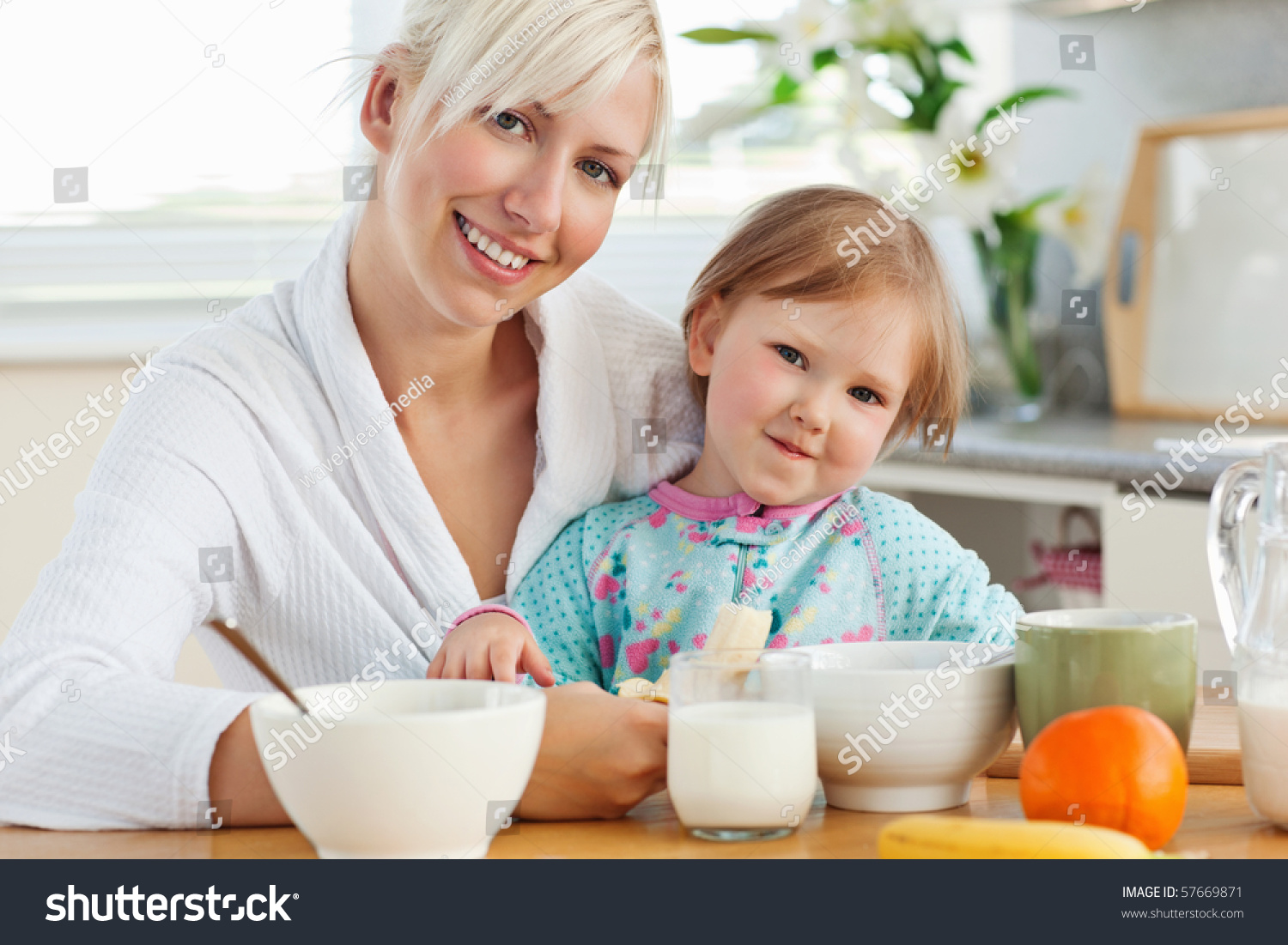 Radiant Mother And Daughter Having Breakfast In The Kitchen Stock Photo ...