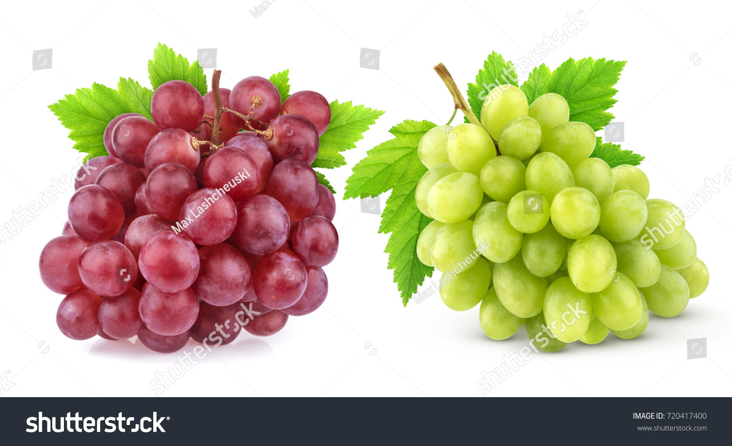 A bunch of red and green grapes with leaves on a white background.