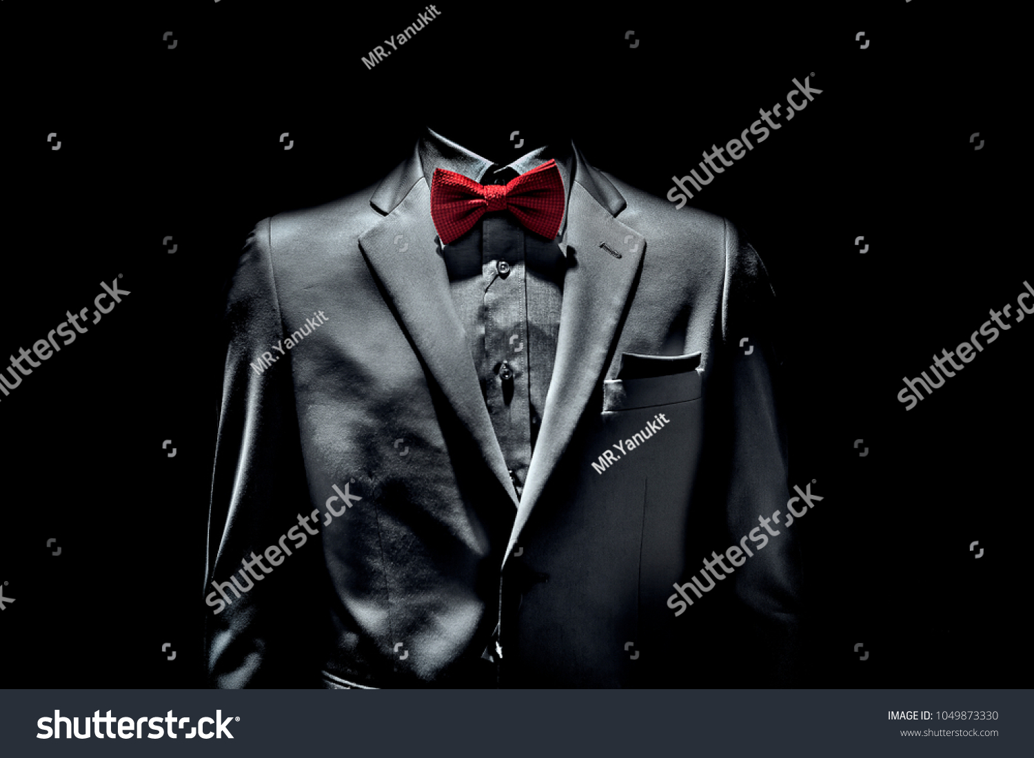 dark grey suit with red bow tie