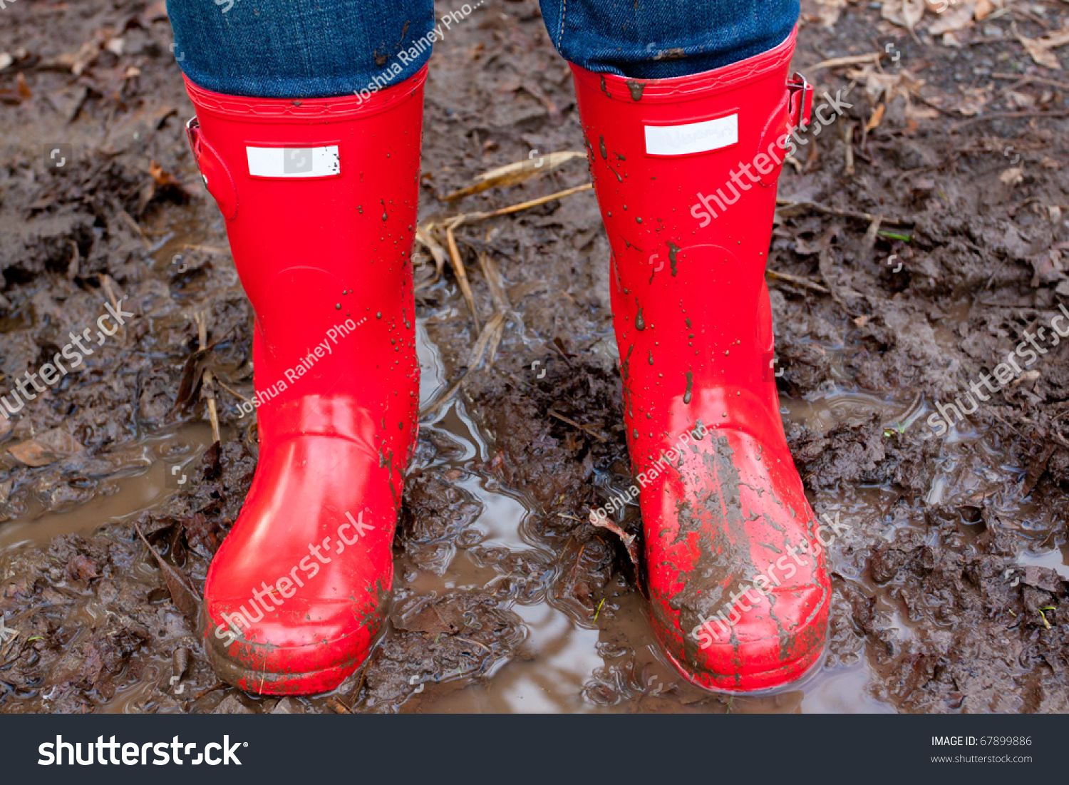 Red Rain Boots On The Legs Of A Girl After She Played In The Mud And ...