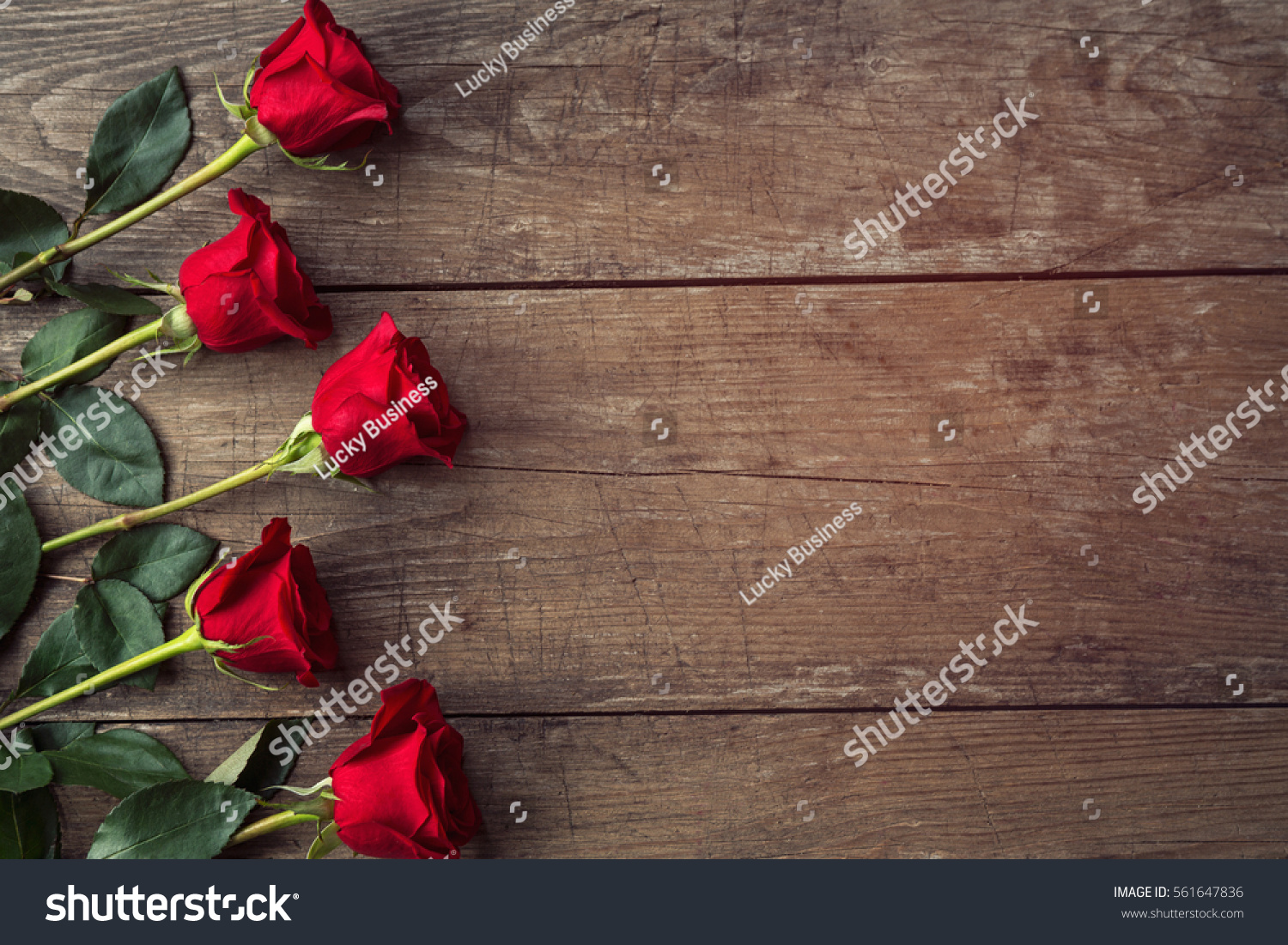 Red Roses On Rustic Wooden Background Stock Photo 561647836 - Shutterstock