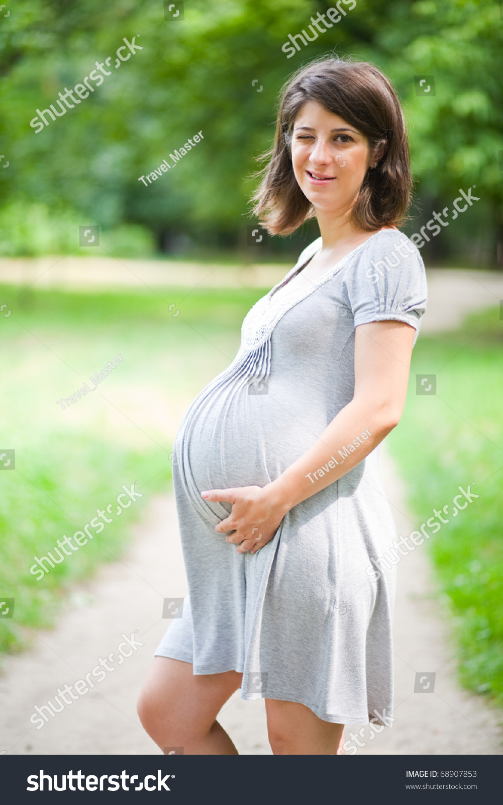 Relaxed Pregnant Woman Winking Holding Belly Stock Photo 68907853 ...