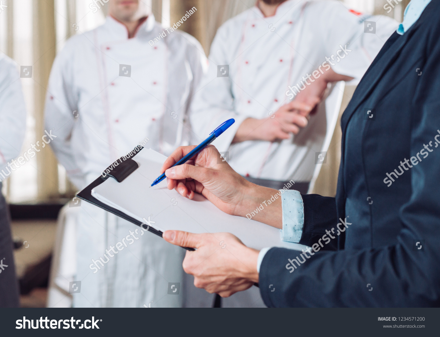 Stock Photo Restaurant Manager And His Staff In Kitchen Interacting To Head Chef In Commercial Kitchen 1234571200 