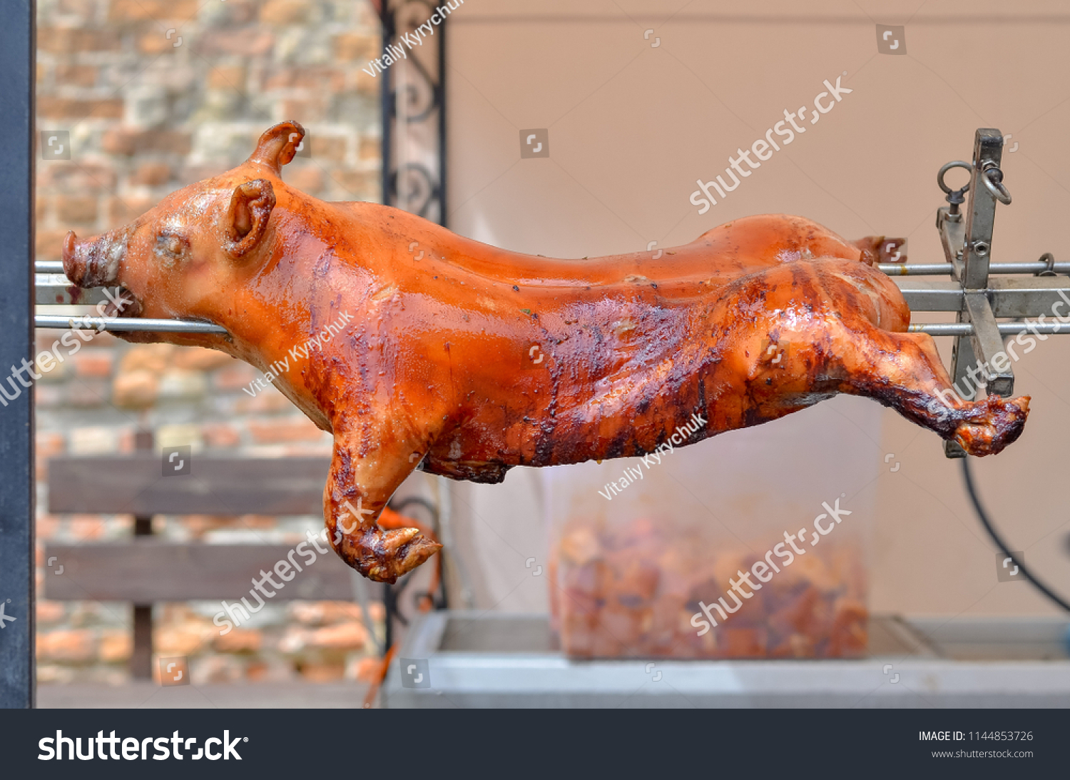 stock-photo-roasted-pig-cooked-on-fire-1144853726.jpg