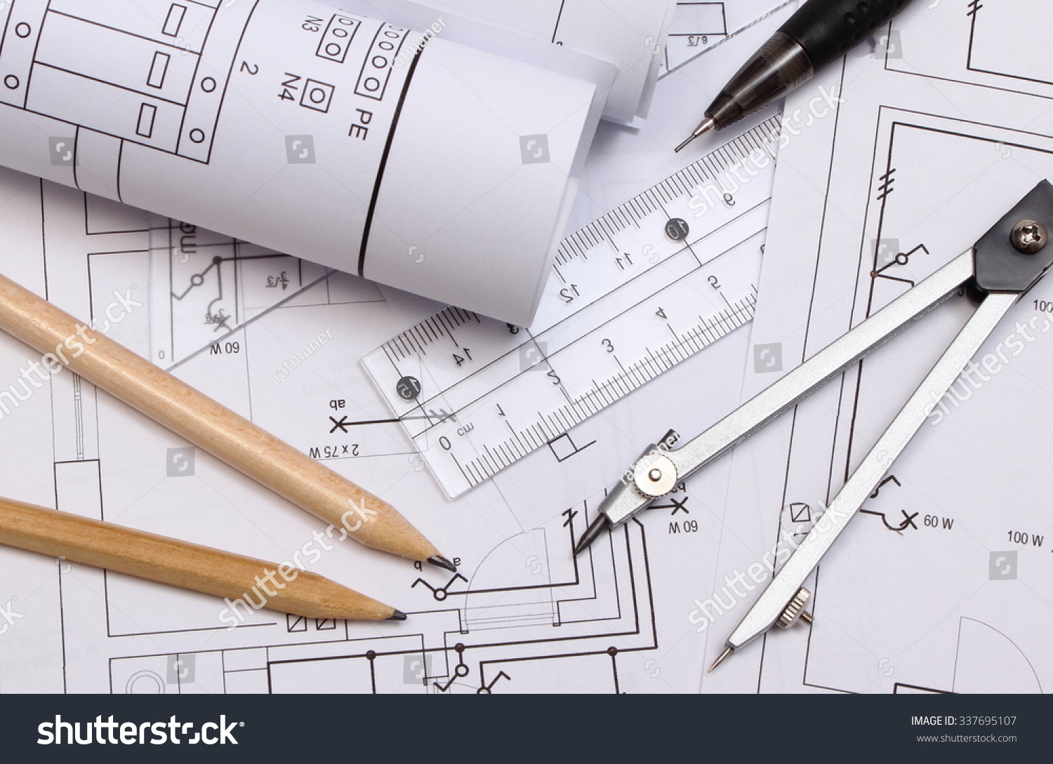 rolls of electrical diagrams and accessories for drawing lying on construction drawing of house drawings rolls of electrical diagrams and accessories for drawing lying on construction drawing of house drawings
