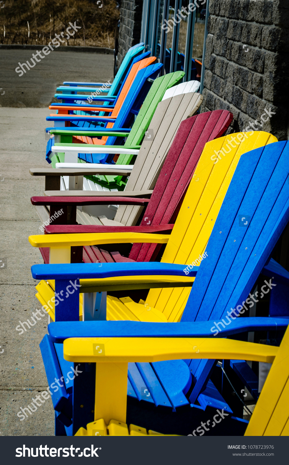 929 Adirondack Chairs People Images Stock Photos Vectors Shutterstock   Stock Photo Row Of Empty Colored Adirondack Chairs Against A Gray Brick Wall And Storefront Windows On A 1078723976 