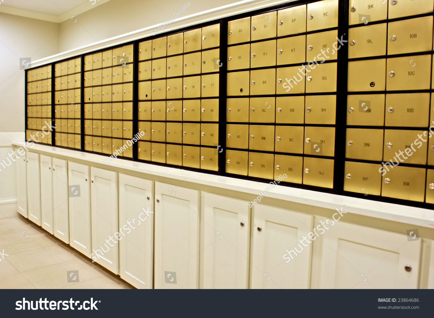 Rows Of Indoor Brass Mailboxes Above Locked Cabinets Stock Photo ...