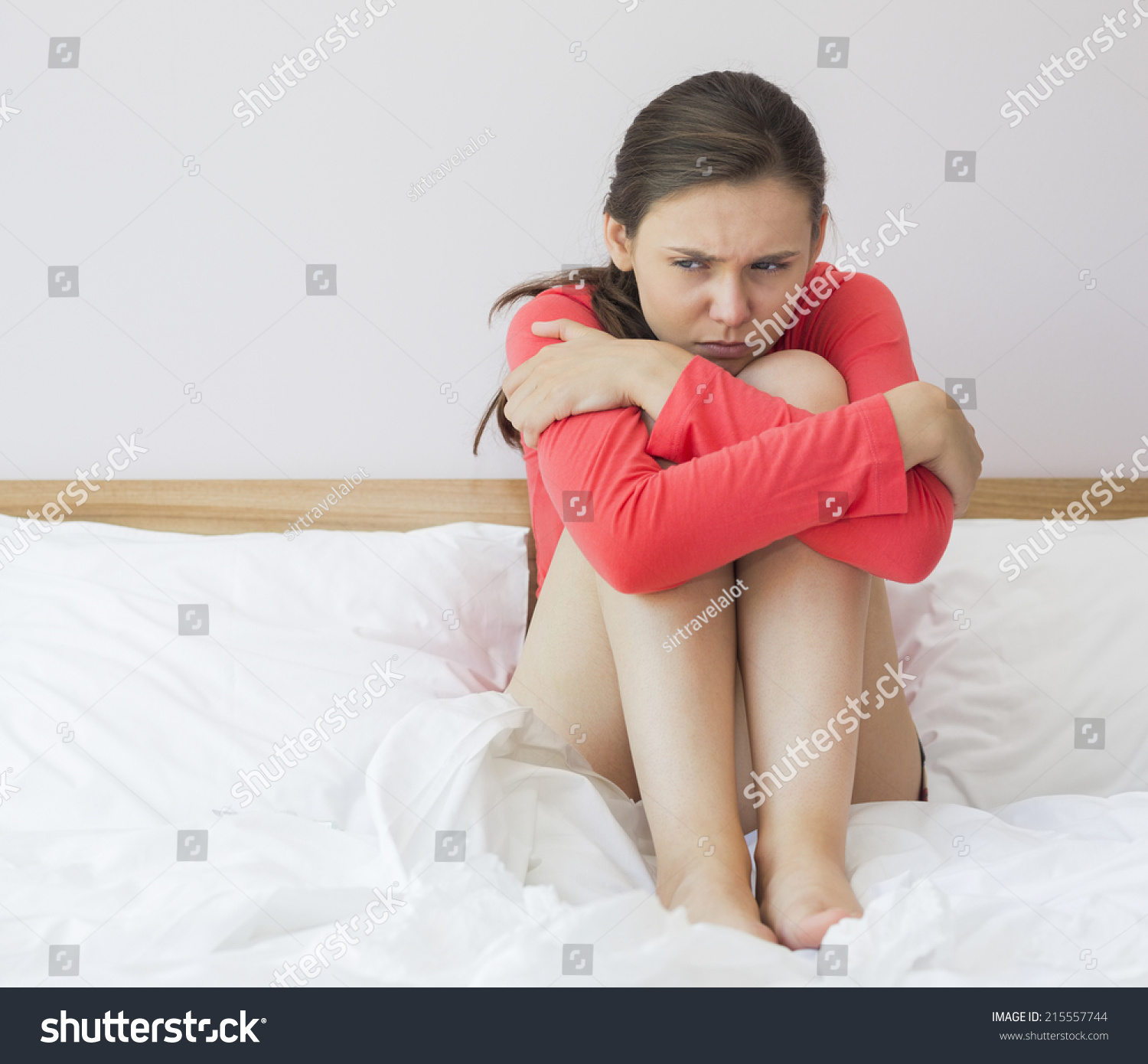 Sad Woman Hugging Knees On Bed Stock Photo (Edit Now) 215557744