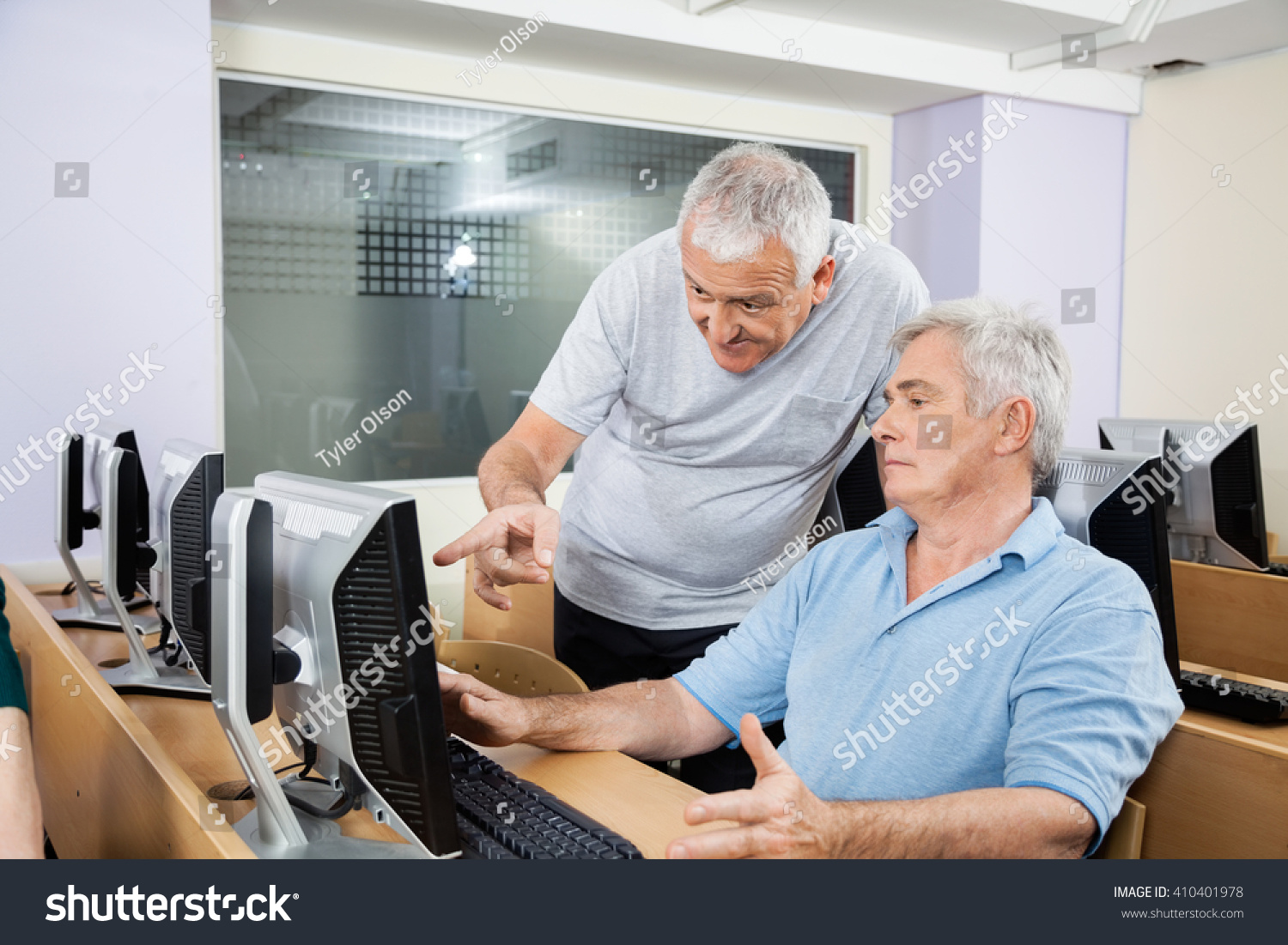 Senior Man Helping Classmate Using Computer Stock Photo 410401978 ...