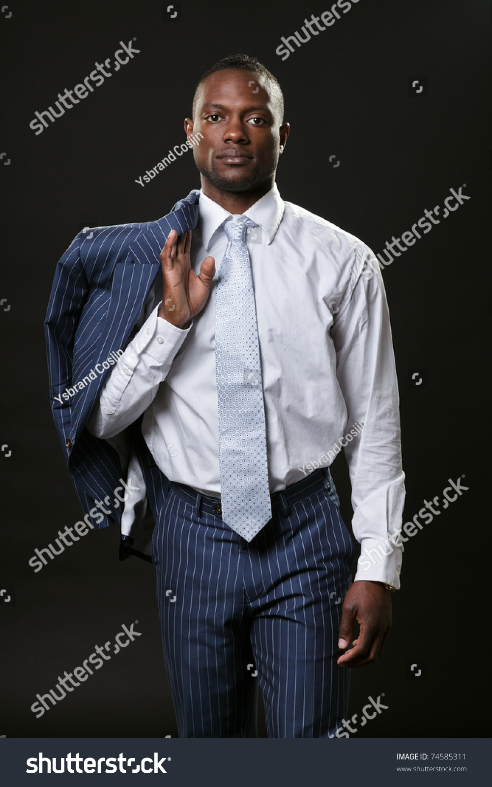 Serious Black Young Business Man In Suit Holds Jacket Over Shoulder ...