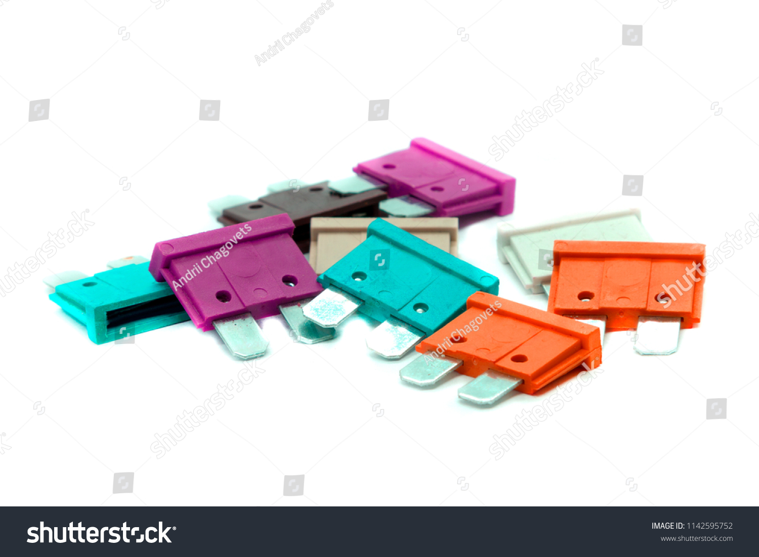 Several multi-colored car fuses for the fuse box. Replacing the electric fuses in