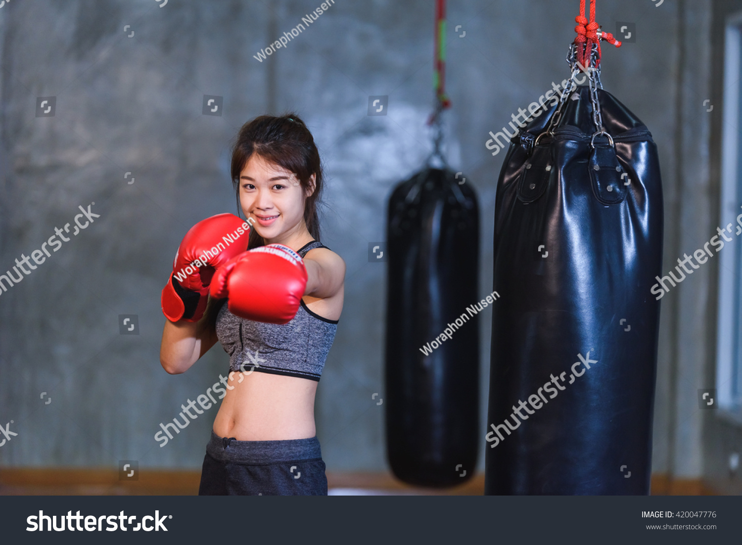 Sexy Asia Girl Punching Boxing Bag Stock Photo 420047776 - Shutterstock