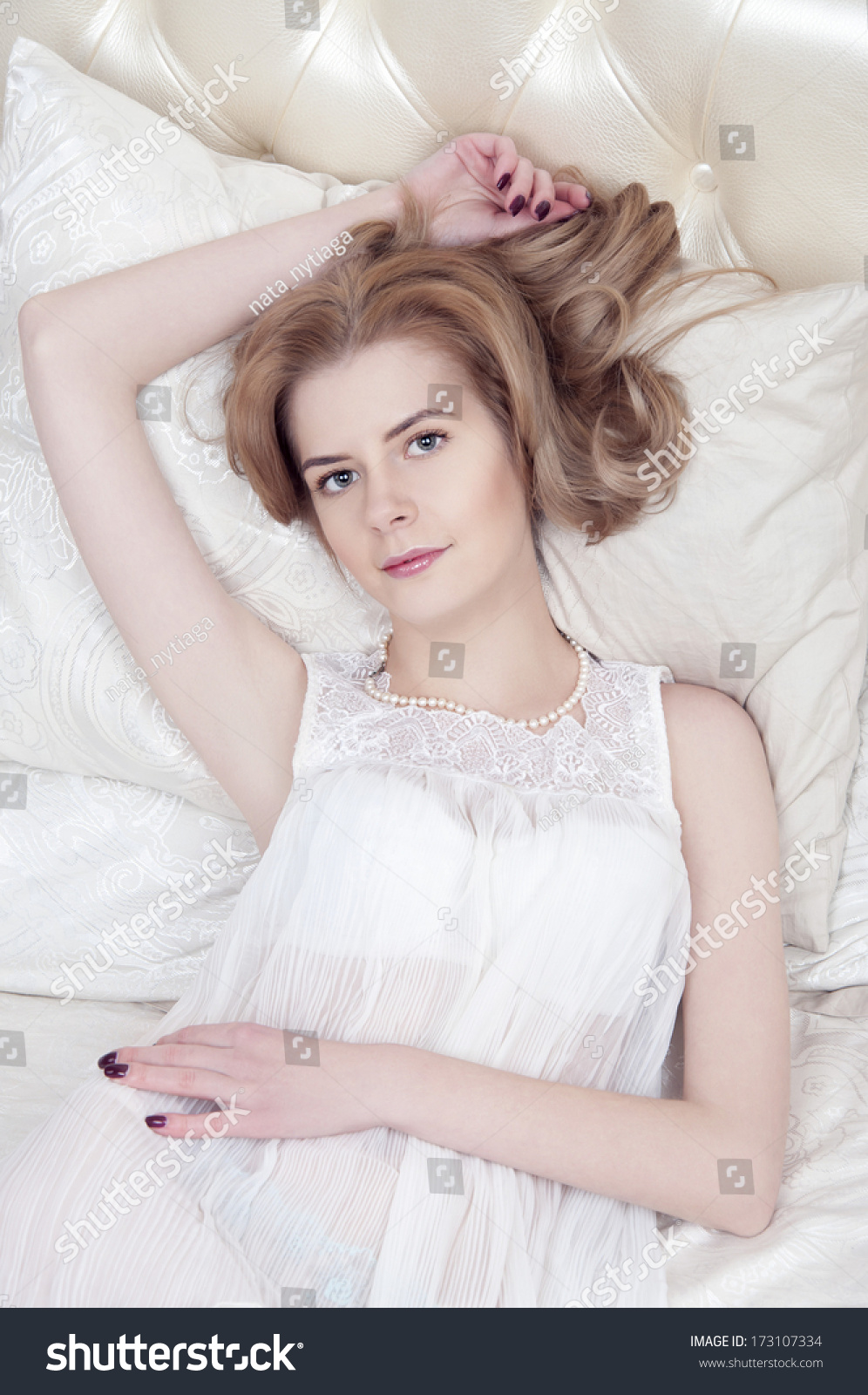 Sexy Blonde Woman In A White Nightgown Laying On The Bed Stock Photo ...