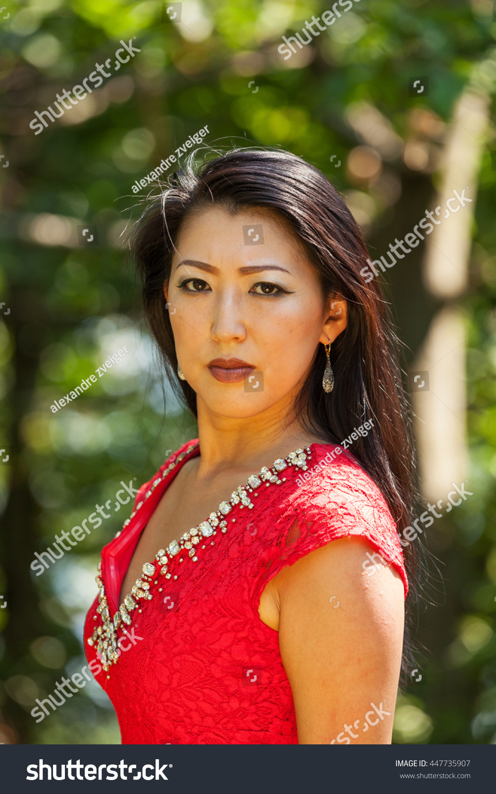 Стоковая фотография 447735907 Sexy Mature Asian Woman Red Dress