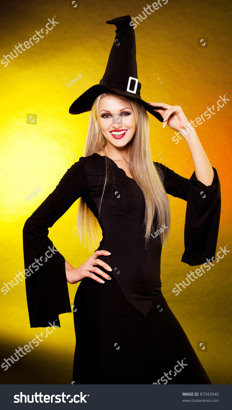 Sexy Smiling Young Blond Witch, Against Yellow Background Stock Photo ...