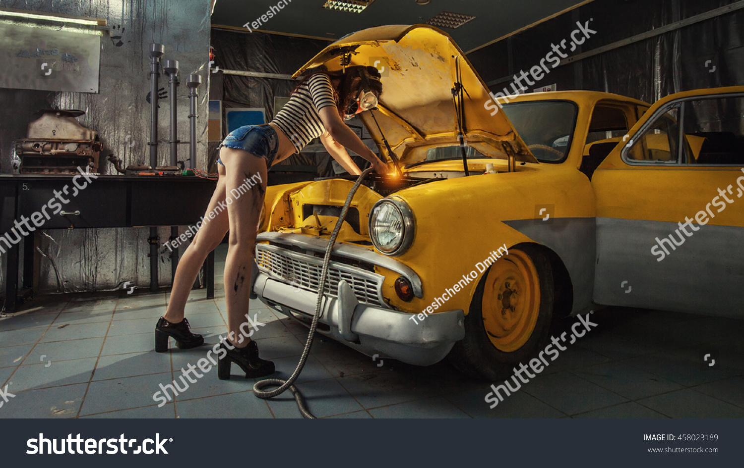 Sexy Woman Welding Something Inside Old Stock Photo