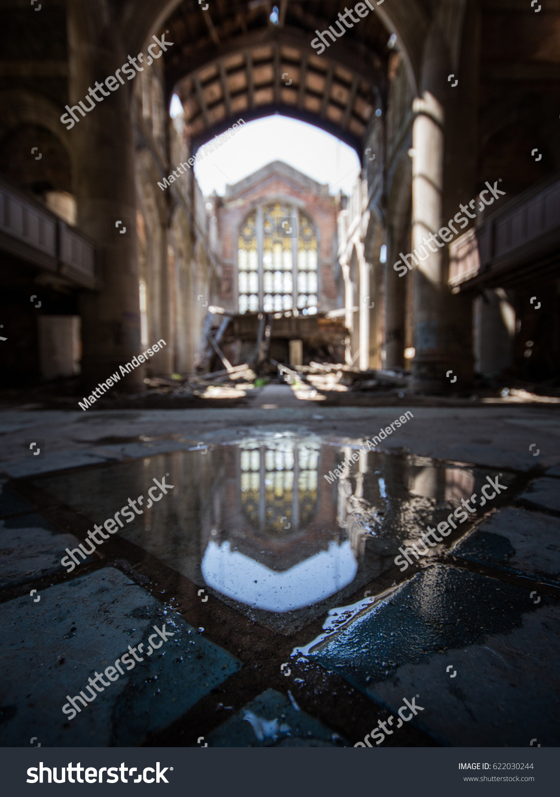 stock-photo-shallow-depth-of-field-of-church-with-puddle-in-focus-on-ground-in-abandoned-building-622030244.jpg