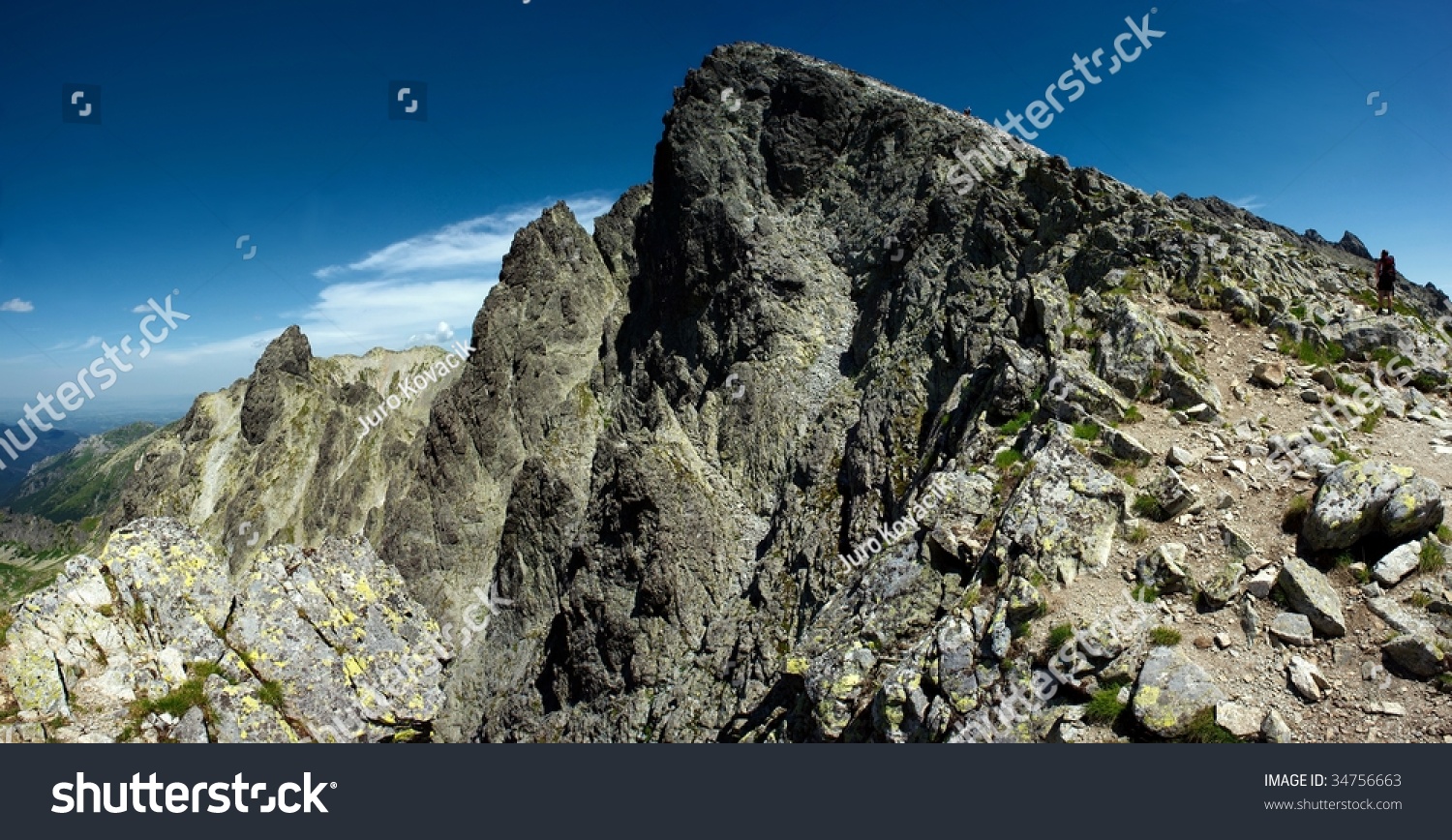 Sharp Mountain Peak With A Hiker, Sunny Day With Blue Sky Stock Photo ...