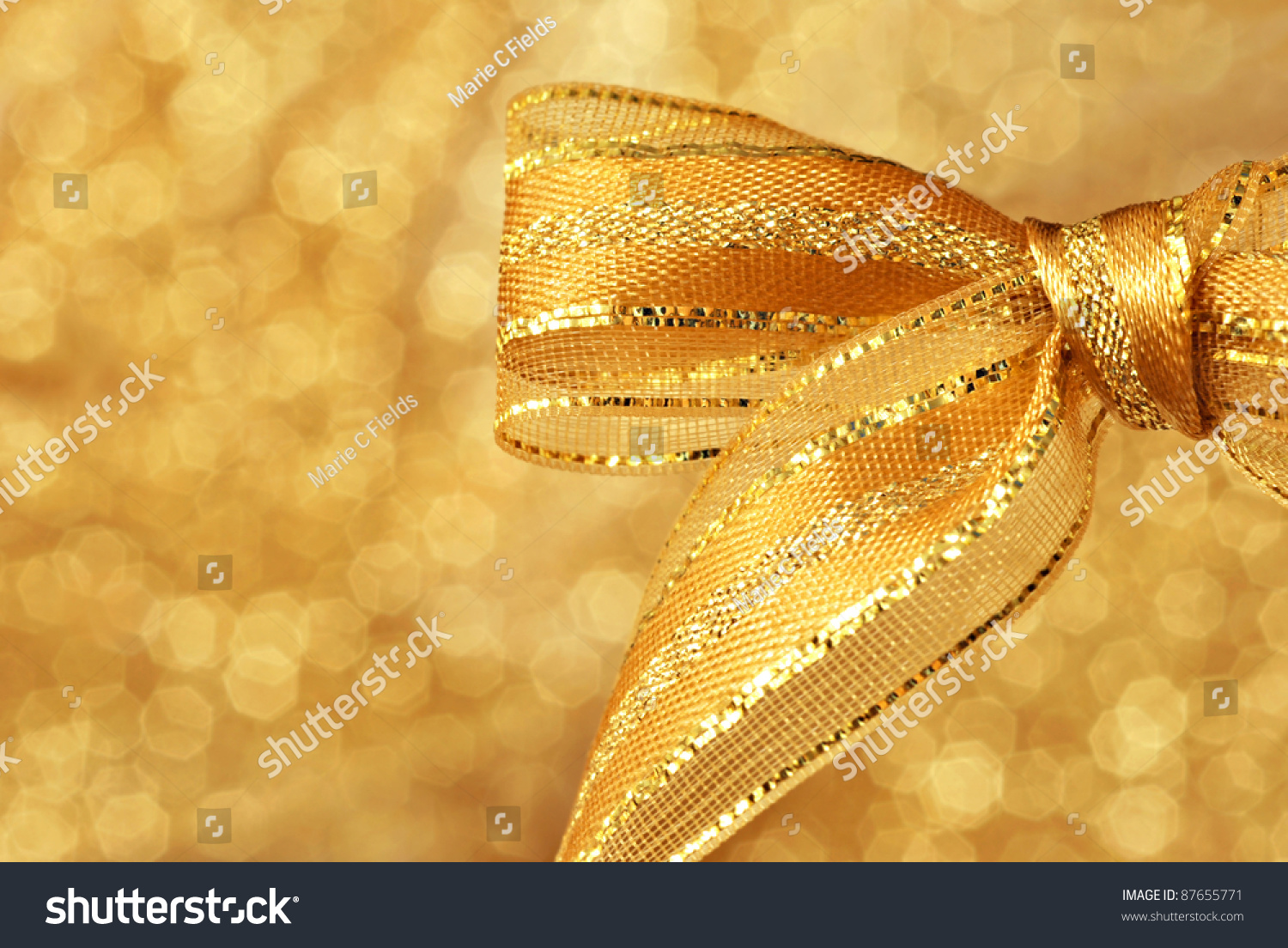 Shiny Gold Metallic Bow Against Background Of Shimmery Gold Fabric ...