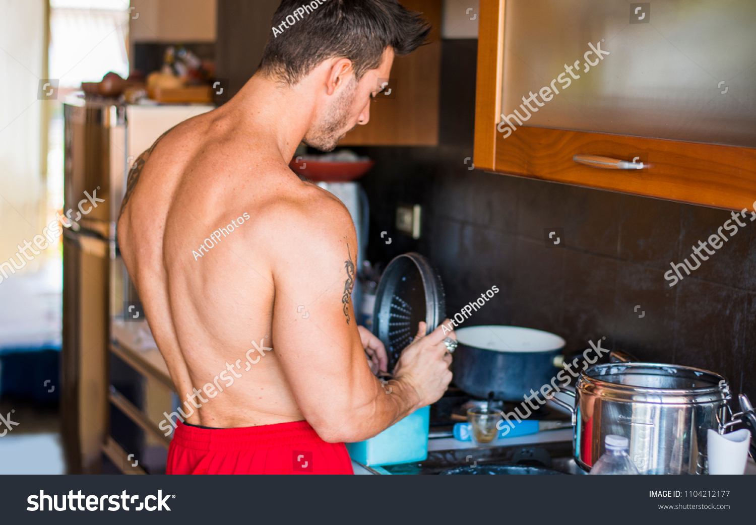 Shirtless Male Bodybuilder Cooking Kitchen Home 1104212177   Stock Photo Shirtless Male Bodybuilder Cooking In Kitchen At Home Preparing Yummy Food 1104212177 