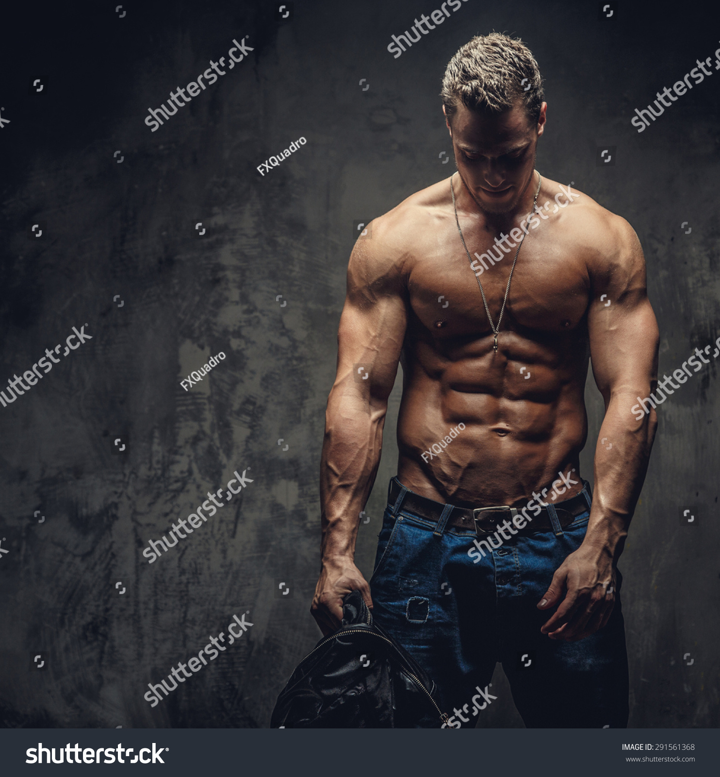 Shirtless Man In Blue Jeans Holding Leather Jacket. Stock Photo ...