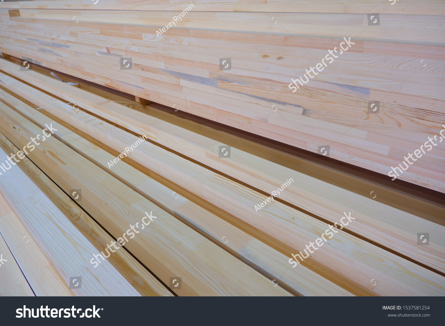 Side view of stack of two-layer wooden glued laminated timber beams from pine finger joint spliced boards for wooden windows