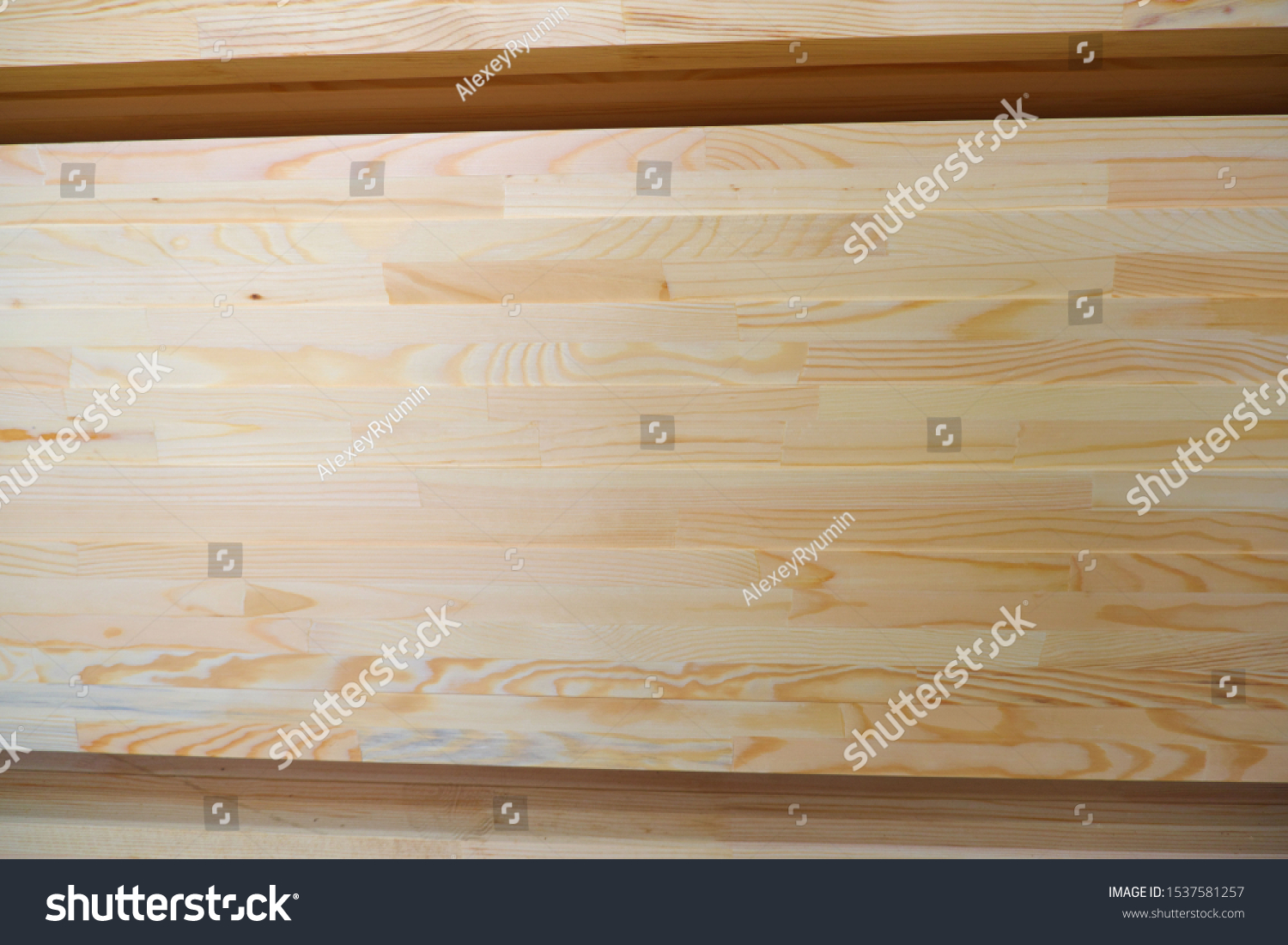 Side view of stack of two-layer wooden glued laminated timber beams from pine finger joint spliced boards for wooden windows