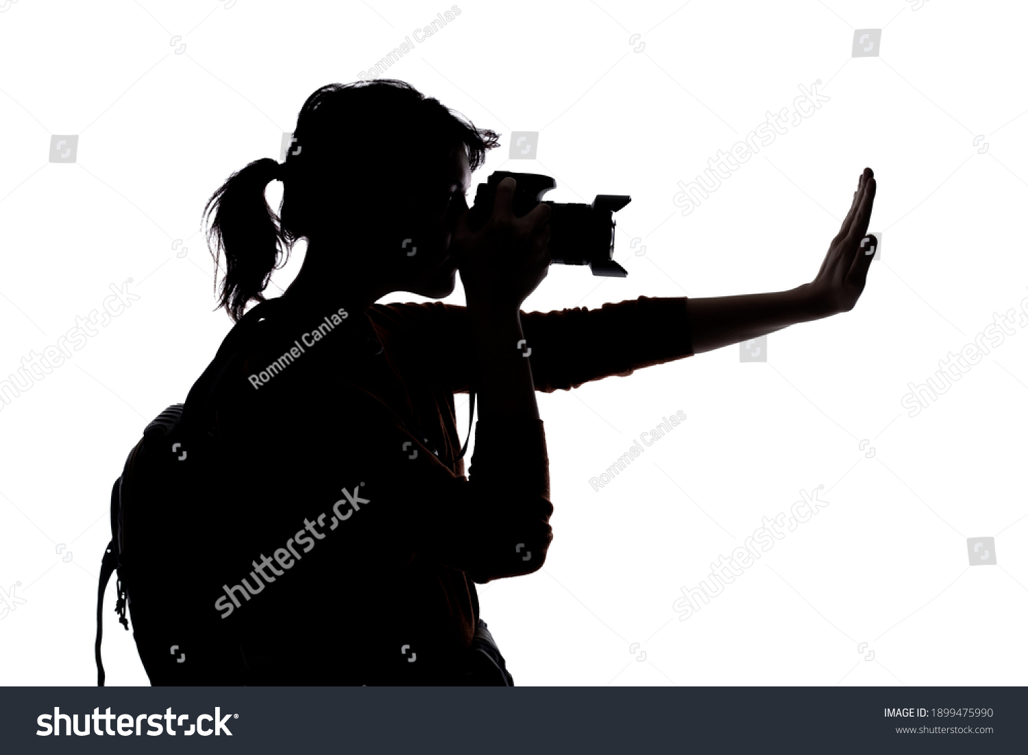 recommend clip art: Silhouette of a photographer with a camera on a white background isolated for composites.  She is posed with a stop gesture