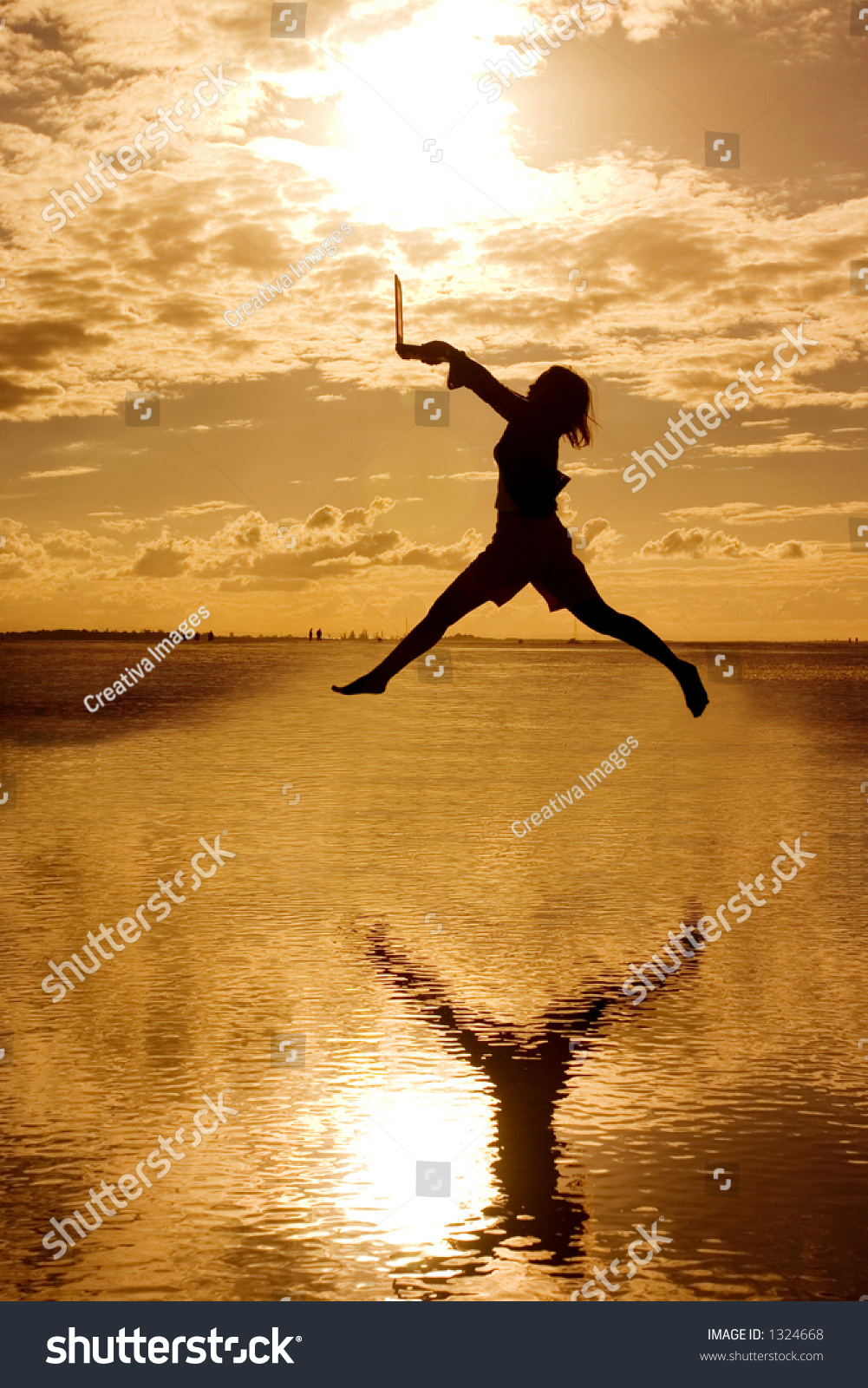 Silhouette Jumping Woman Holding Laptop Computer Stock Photo 1324668 ...