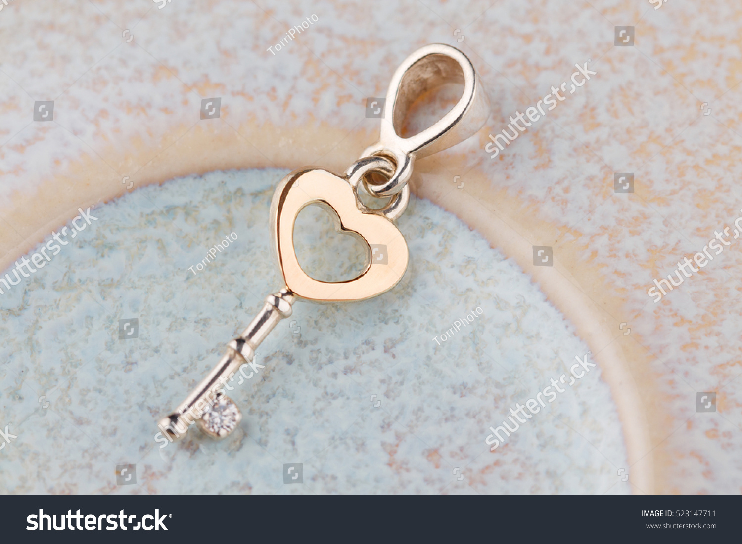 https://www.shutterstock.com/pic-523147711/stock-photo-silver-and-gold-key-pendant-necklace-romantic-jewelry-for-valentines-day.html