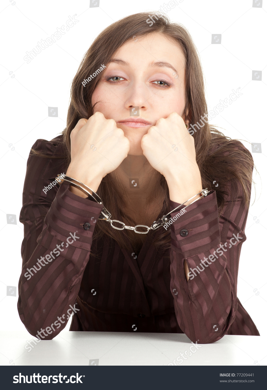 Sitting Young Woman In Brown Blouse With Handcuffed Hands Stock Photo ...