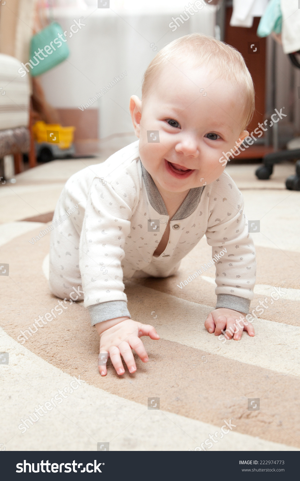 Six Month Old Baby Crawling On The Carpet In The Room. Stock Photo ...