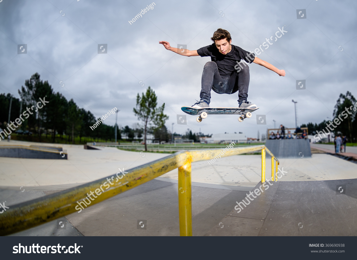 Skateboarder Doing Ollie Over Rail Skate Stock Photo 369690938 ...