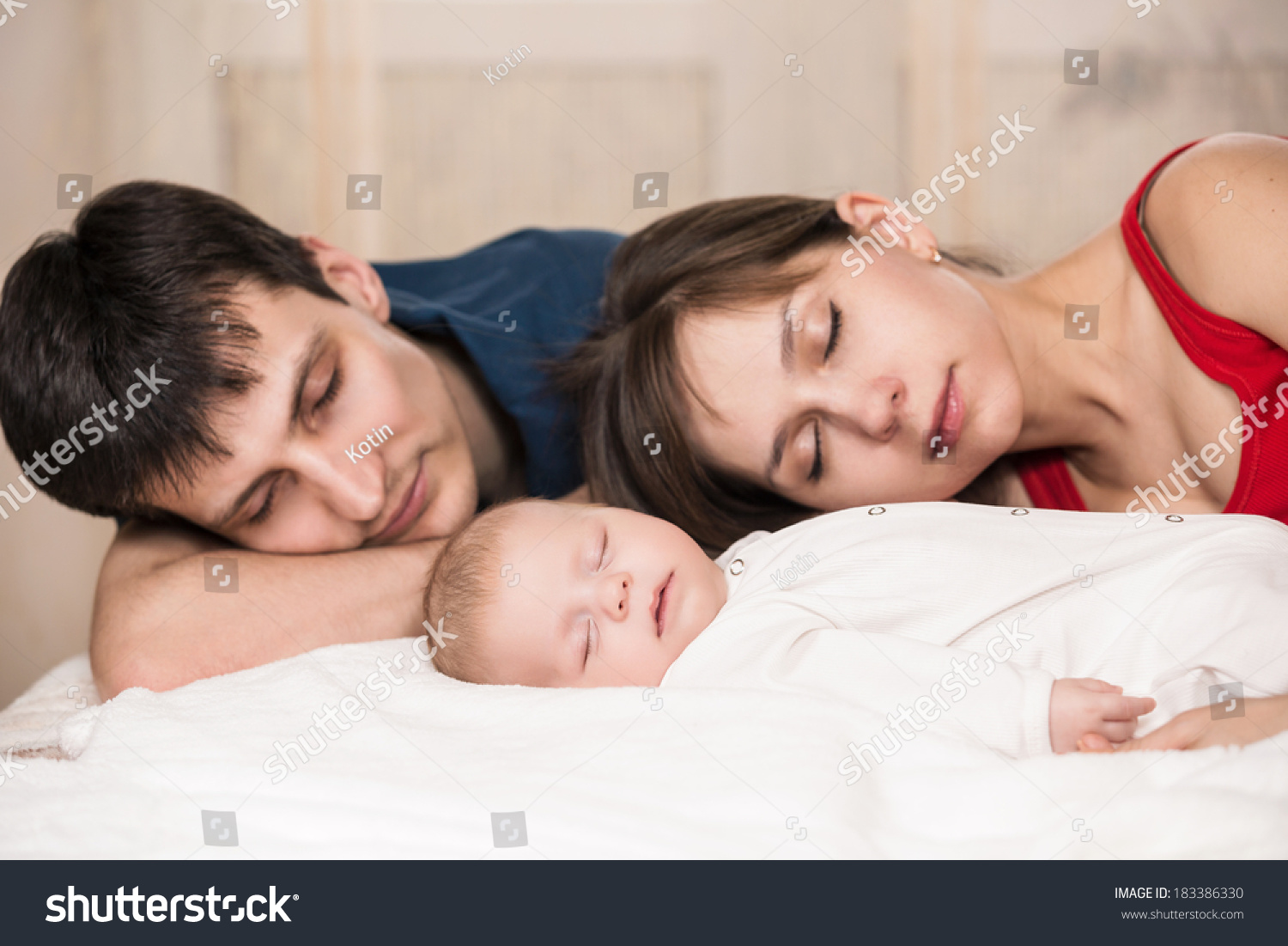 mom and dad sleeping with baby