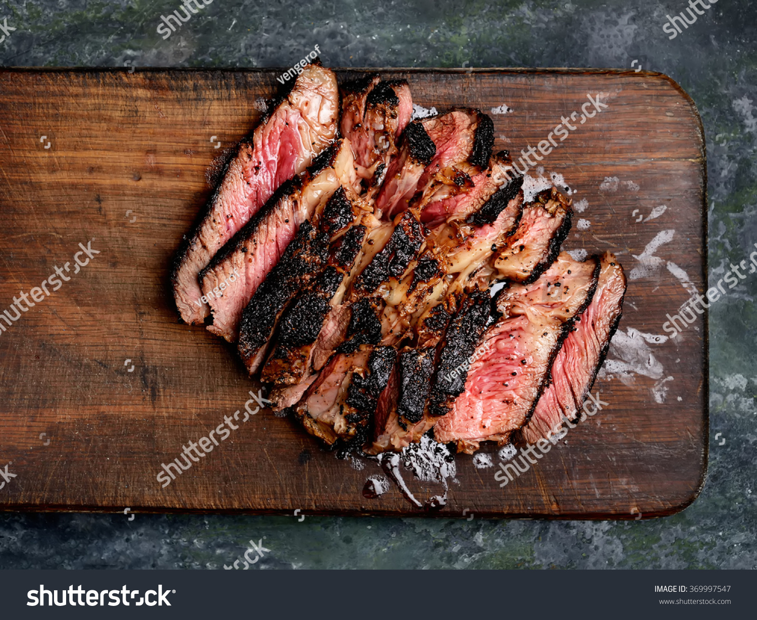 Grilled Steak With Knife In Cutting Board Sliced Grilled Beef Steak Knife Fork Stock Photo 369997547