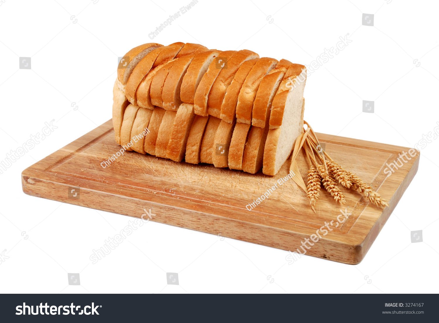 Sliced Loaf Of Bread On Wooden Chopping Board With Wheat Ears Stock ...