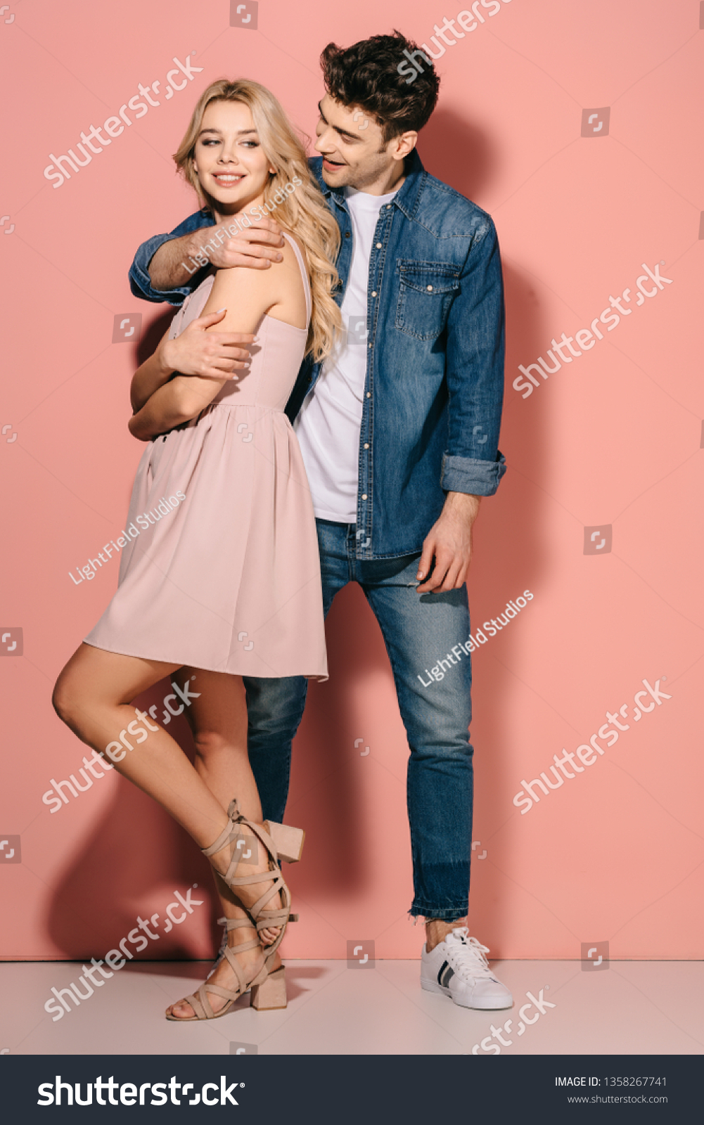 Стоковая фотография 1358267741: Smiling Girlfriend Pink Dress Handsome ...