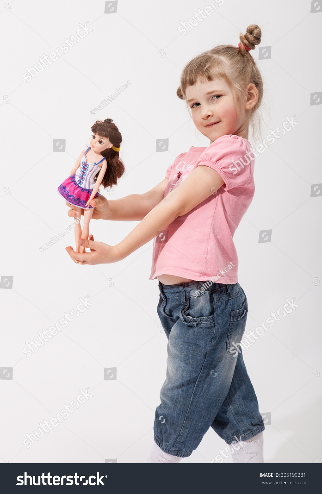 little girl holding doll