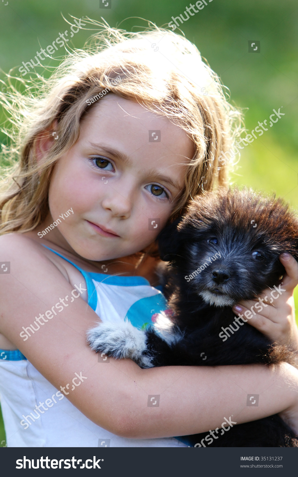 Smiling Little Girl Hugging A Big Black Dog In An Outdoor Setting Stock ...