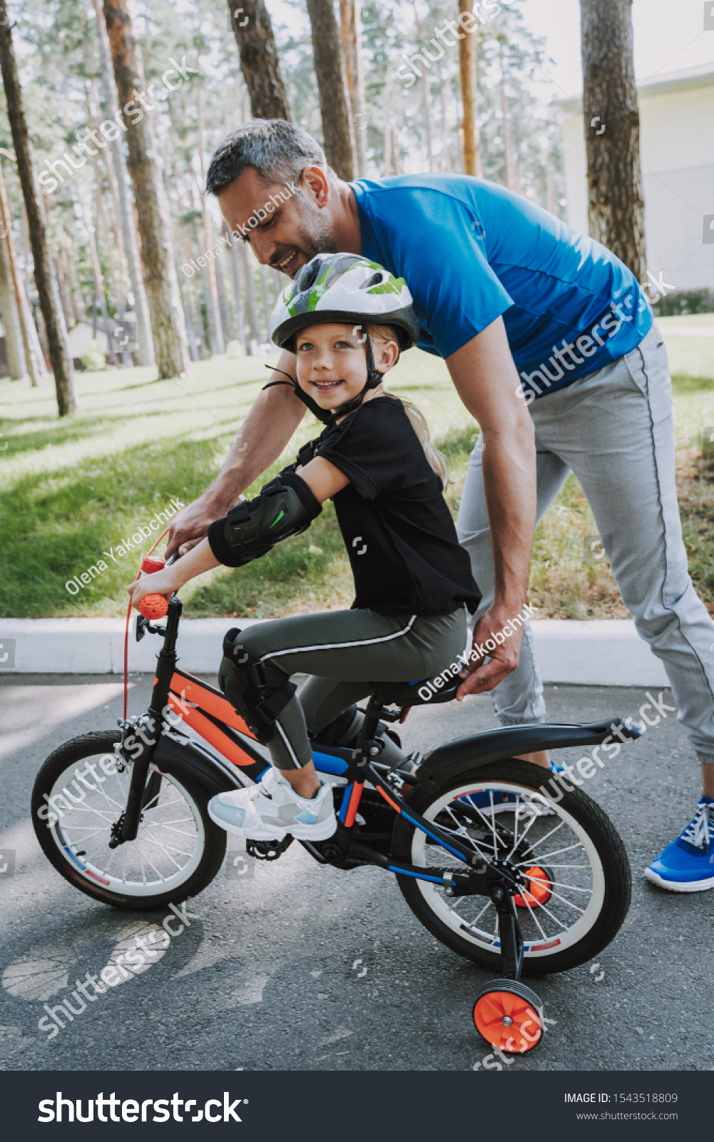 girl learning to ride a bike