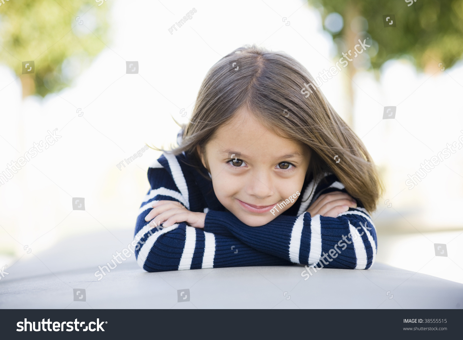 smiling-young-girl-lying-on-stomach-stock-photo-38555515-shutterstock