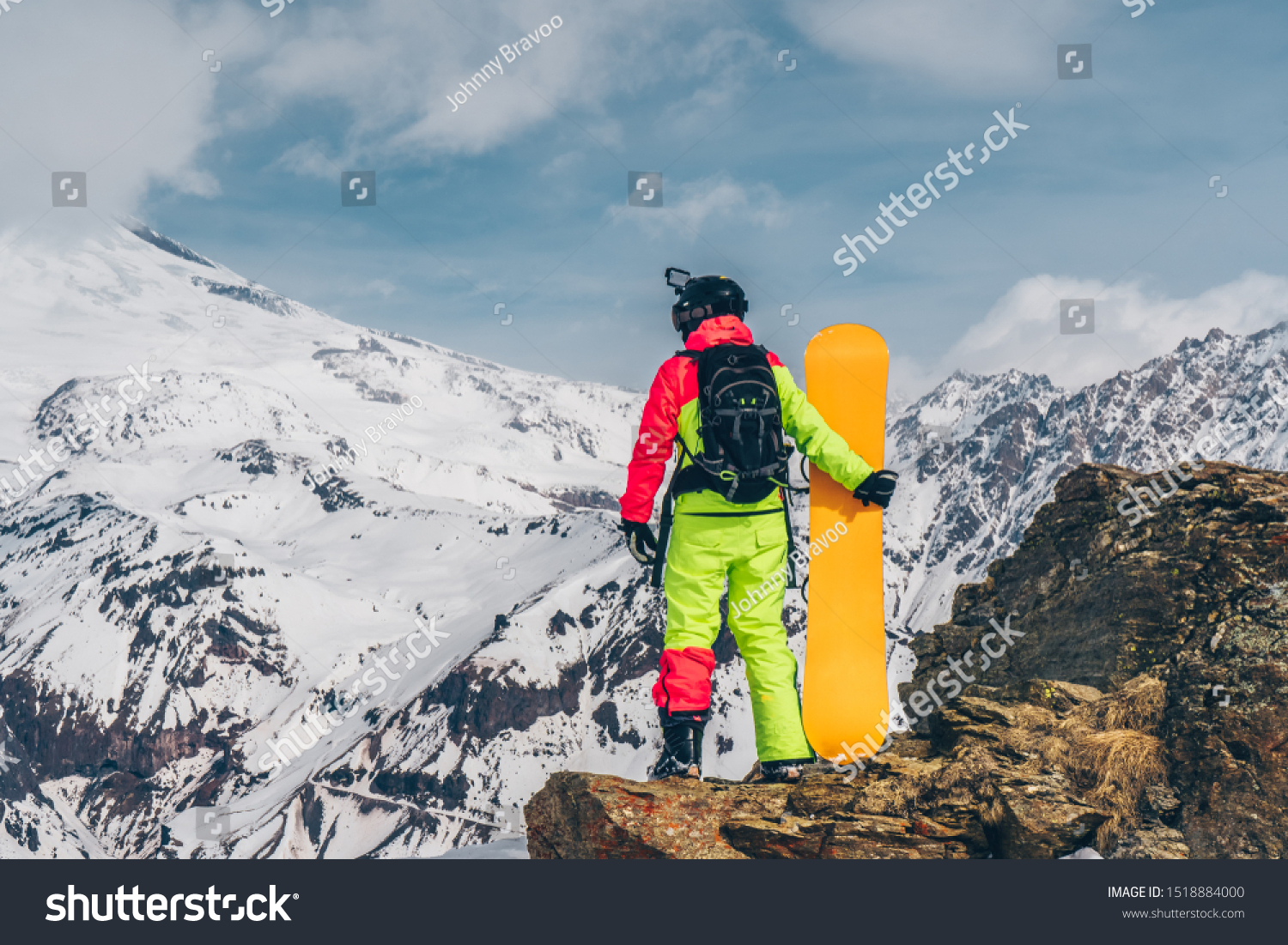 Snowboarder Orange Snowboard Standing On Rock Stock Photo Edit Now