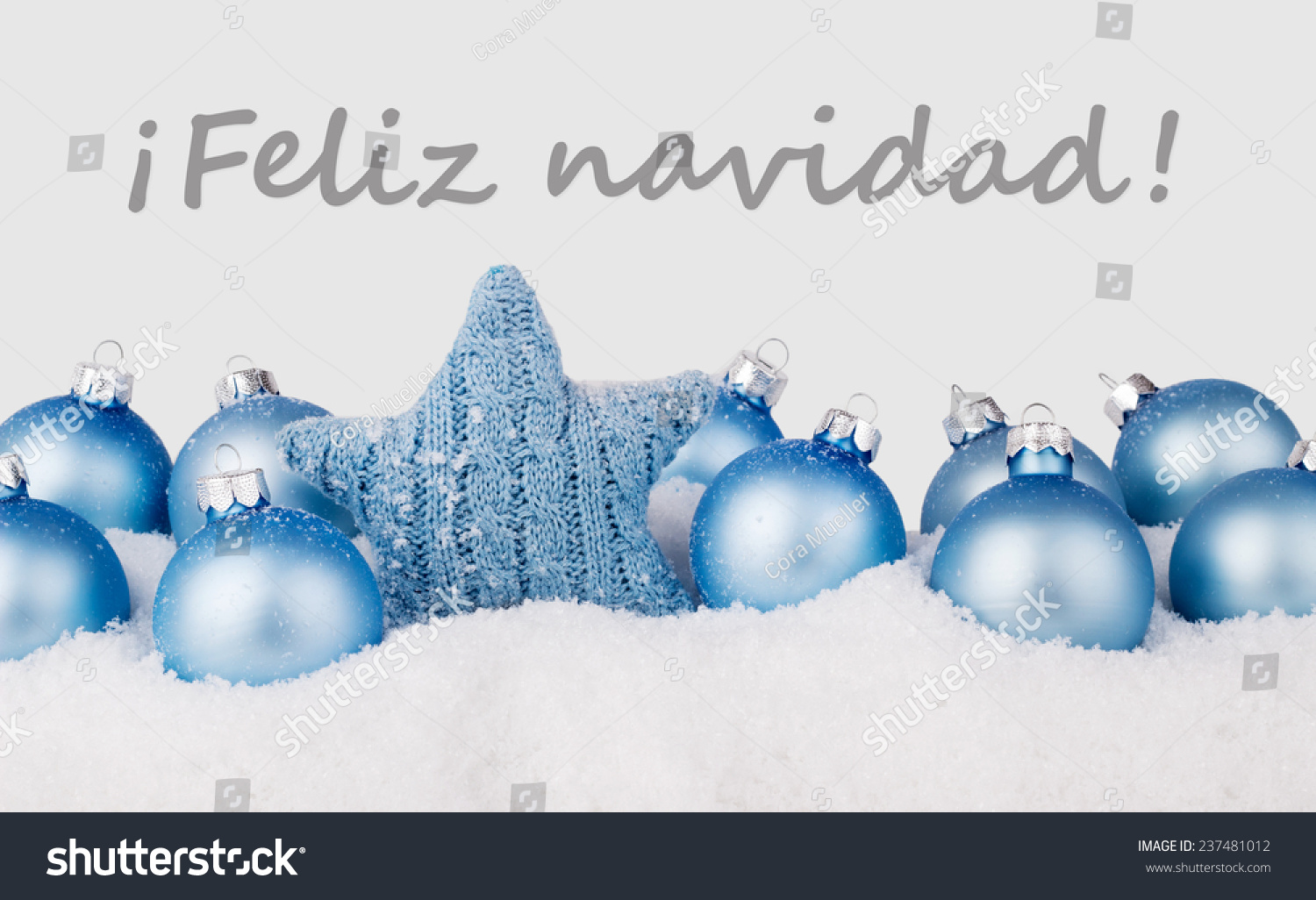 Spanish Christmas Card With Blue Christmas Balls And Text Merry Christmas/Merry Christmas